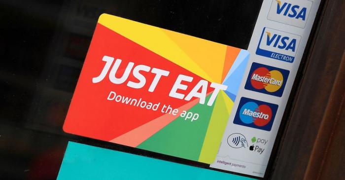 FILE PHOTO: Signage for Just Eat is seen on the window of a restaurant in London, Britain