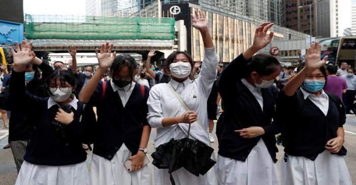 FILE PHOTO: Demonstrators wear face masks during an anti-government protest in Central, Hong