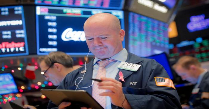 Traders work on the floor at the NYSE in New York