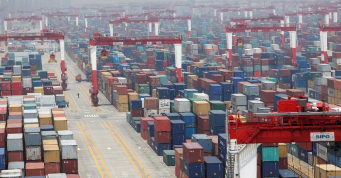 FILE PHOTO: A man walks in a shipping container area at Yangshan Port of Shanghai