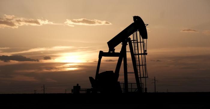 Oil pump jacks work at sunset near Midland