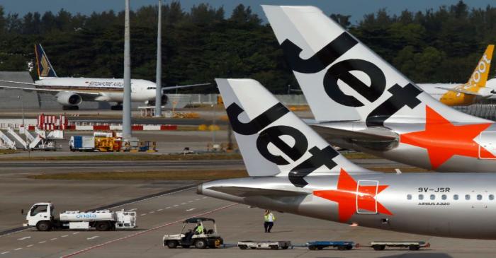 FILE PHOTO: Budget airline Jetstar aircrafts sit on the tarmac at Singapore's Changi Airport