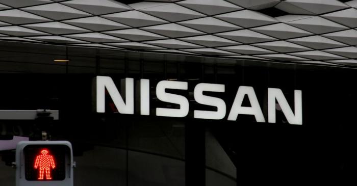 FILE PHOTO: The logo of Nissan Motor Co. is seen at its show room behind a traffic sign in