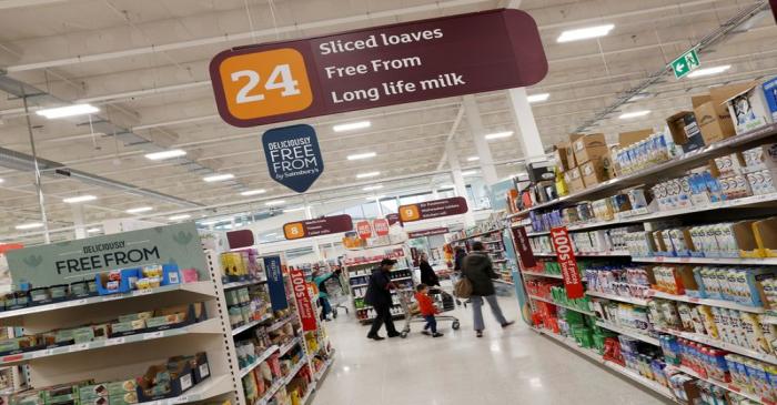 FILE PHOTO: Customers shop in a Sainsbury's store in Redhill