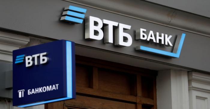 FILE PHOTO: Logos are on display outside a branch of VTB bank in Moscow