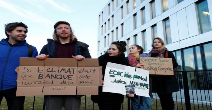 Activists protest outside the District Court of West Lausanne before the trial of twelve