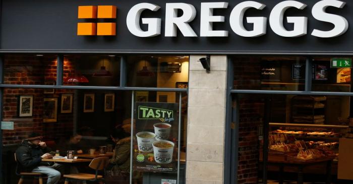 FILE PHOTO: People sit inside a Greggs bakery in Bradford, Britain