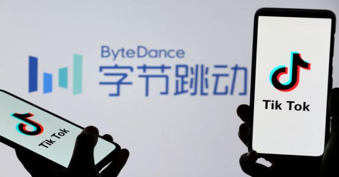 FILE PHOTO: Tik Tok logos are seen on smartphones in front of displayed ByteDance logo in this