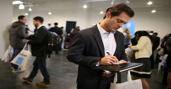 FILE PHOTO: People attend TechFair LA, a technology job fair, in Los Angeles