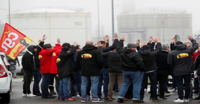 Workers of French oil giant Total gather in front of the oil refinery in Donges