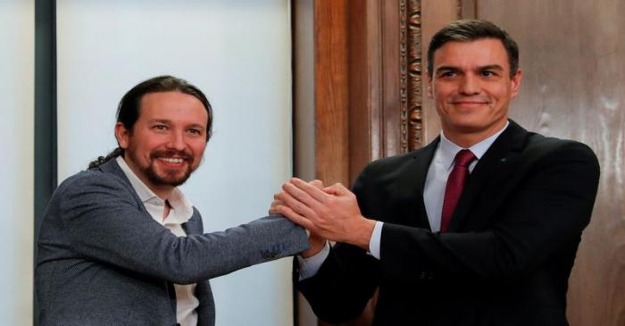 FILE PHOTO: Spain's acting PM Sanchez and Unidas Podemos leader Iglesias present their