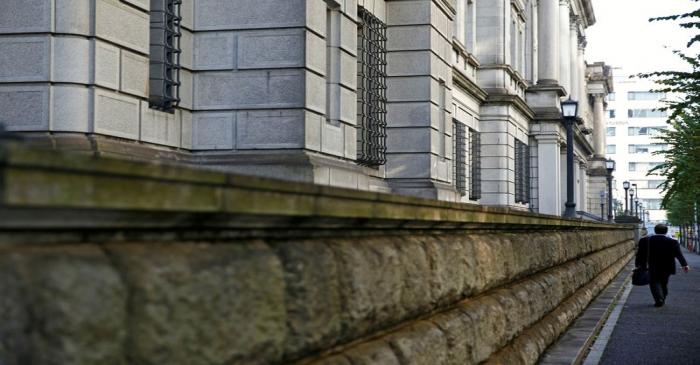 FILE PHOTO: A man walks past the Bank of Japan building in Tokyo