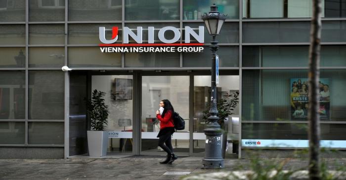 People walk past insurance company Union HQ in Budapest