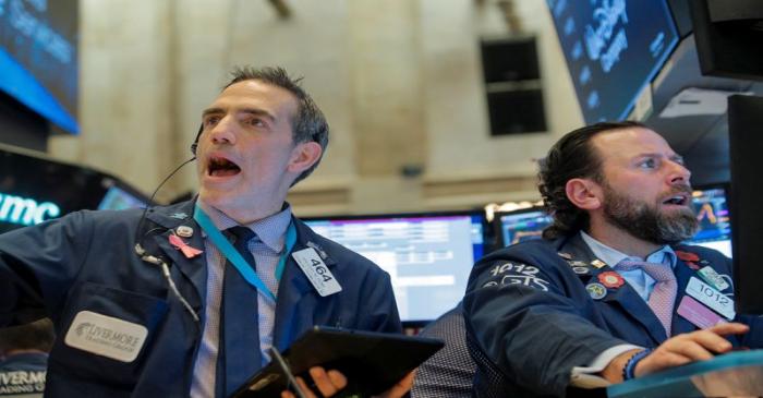 Traders work on the floor at the NYSE in New York