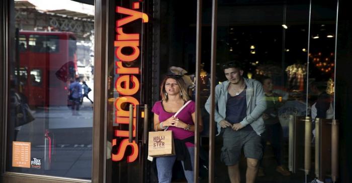 People leave a Superdry store in central London