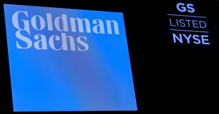 FILE PHOTO: The ticker symbol and logo for Goldman Sachs is displayed on a screen on the floor