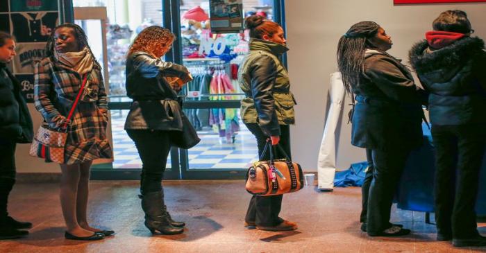 People wait in line to register to a screening session for seasonal jobs at Coney Island in the