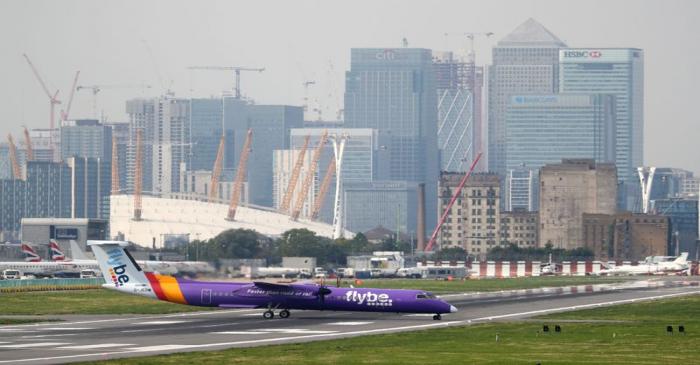 A Flybe Bombardier Dash 8 Q400 airplane taxis at City Airport in London