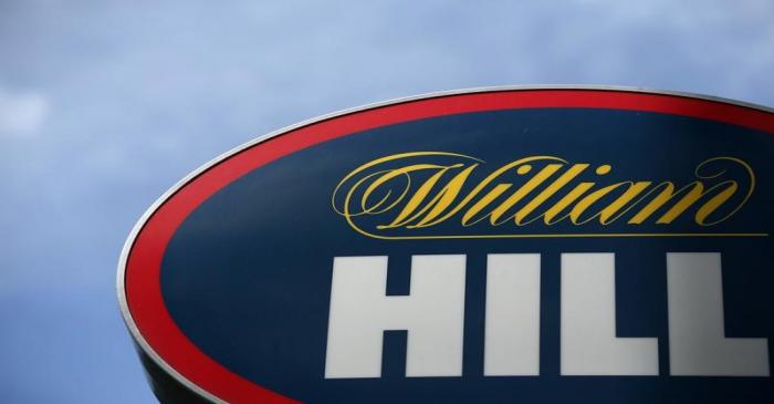 A branded sign is displayed outside a William Hill betting shop in London