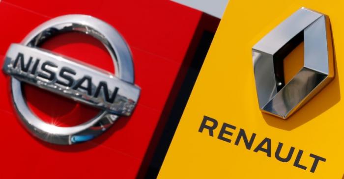 The logos of car manufacturers Renault and Nissan are seen in front of dealerships of the