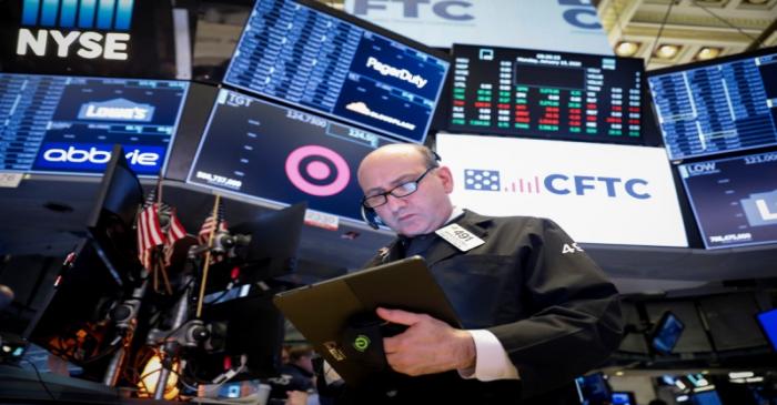 FILE PHOTO:  Traders work on the floor at the NYSE in New York