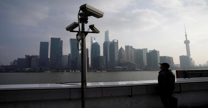 A man stands on the Bund in front of Shanghai's financial district of Pudong in Shanghai