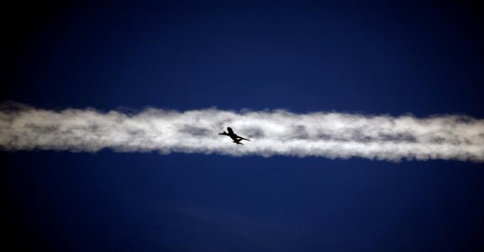 FILE PHOTO: FILE PHOTO: An aeroplane flies beneath the jet stream of another above the Italian