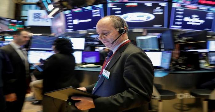 FILE PHOTO:  Traders work on the floor at the NYSE in New York