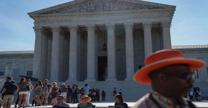 FILE PHOTO: Visitors wait to enter the U.S. Supreme Court in Washington