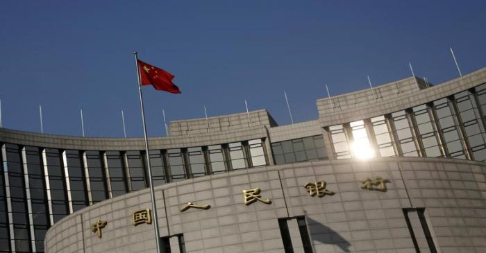 A Chinese national flag flies at the headquarters of the People's Bank of China, the country's