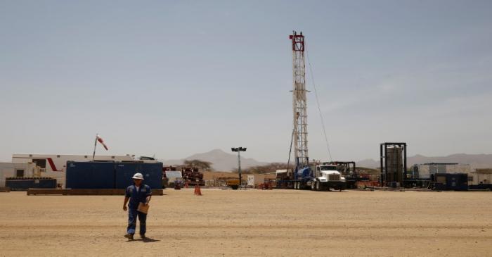 FILE PHOTO: Worker walks at a Tullow Oil explorational drilling site in Lokichar