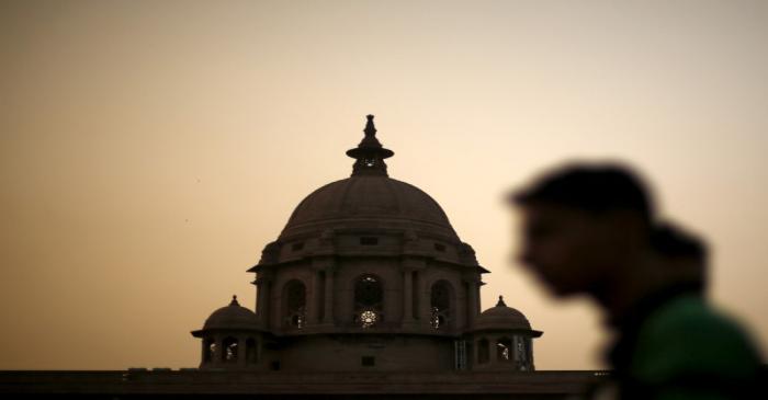 FILE PHOTO: A commuter walks past the building of India's Ministry of Finance during dusk in