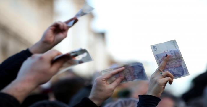 FILE PHOTO: Shoppers bid for cuts of meat during a Christmas Eve auction in Smithfield market