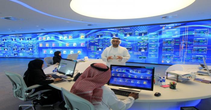 Employees are seen at the Panorama Digital Command Centre at the ADNOC headquarters in Abu