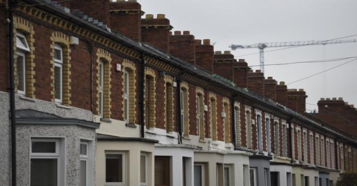 A crane is seen behind a row of residential properties in the Capital Dock area of Dublin