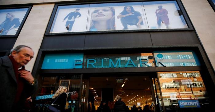 Shoppers walk past a Primark store on Oxford Street in London