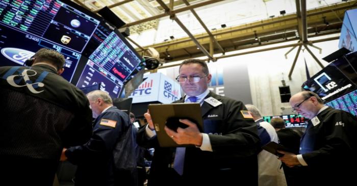 Traders work on the floor at the NYSE in New York