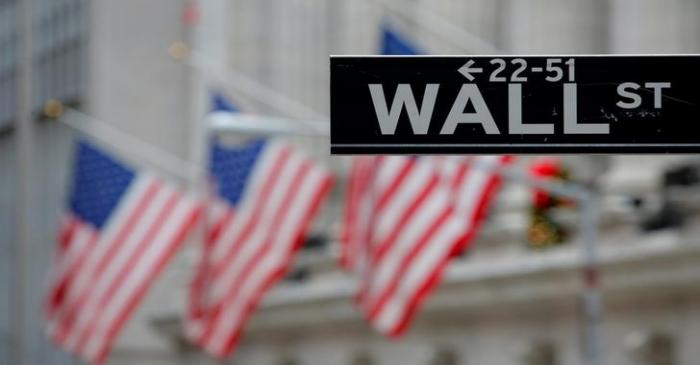 FILE PHOTO: A street sign for Wall Street is seen outside the New York Stock Exchange in