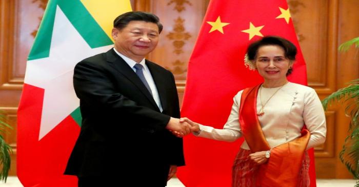 Myanmar State Counselor Aung San Suu Kyi shakes hands with Chinese President Xi Jinping at the