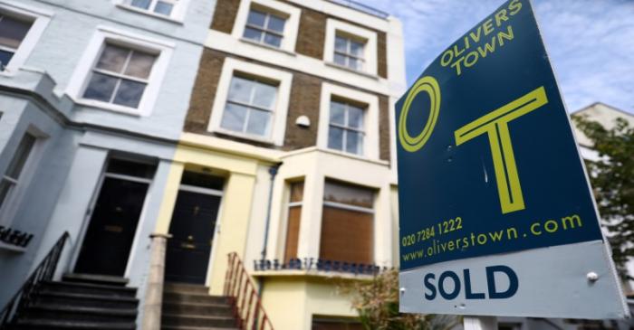 FILE PHOTO: An estate agent board is displayed outside a property in London