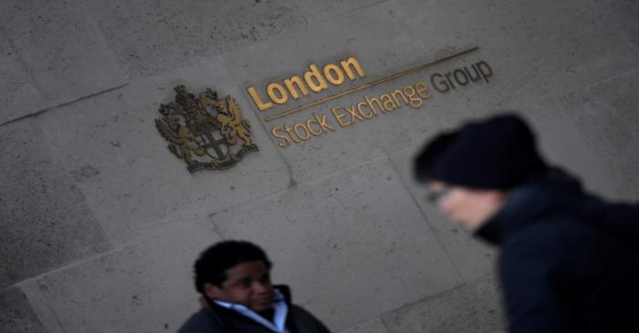 People walk past the London Stock Exchange Group offices in the City of London