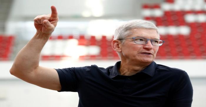 Apple's CEO Tim Cook speaks with Singapore Paralympian Theresa Goh (unseen) at the OCBC Aquatic