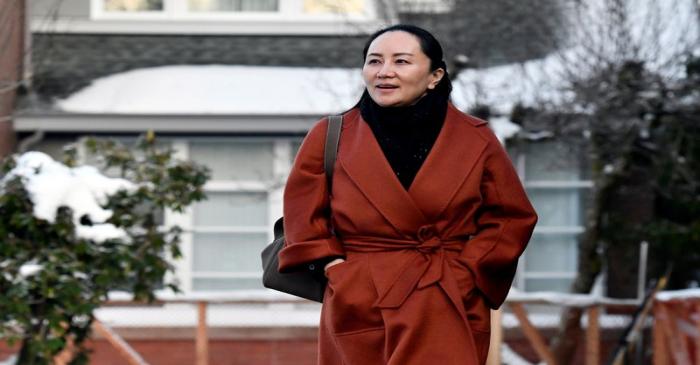 FILE PHOTO: Huawei Chief Financial Officer Meng Wanzhou leaves her home to attend a case