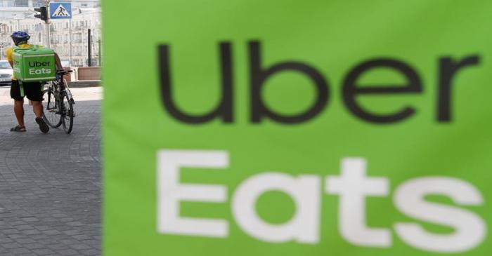 An Uber Eats courier walks in Kiev