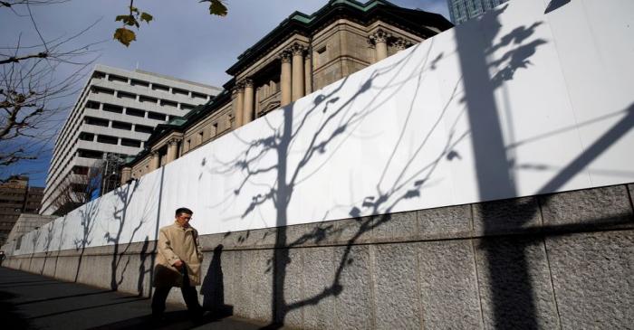 FILE PHOTO: Man walks past the Bank of Japan building in Tokyo