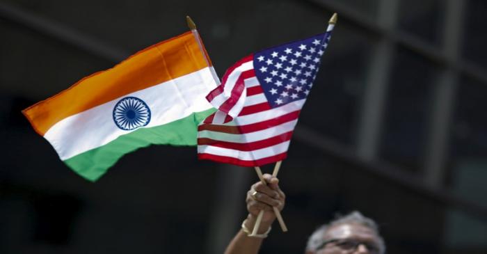 FILE PHOTO: Man holds the flags while people take part in the 35th India Day Parade in New York