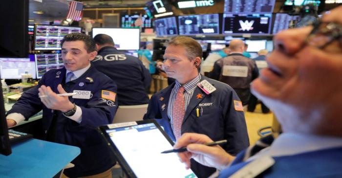 Traders work on the floor of the New York Stock Exchange shortly after the opening bell in New