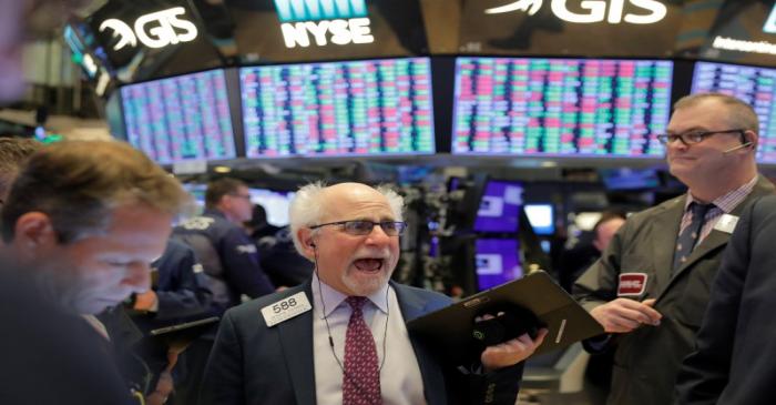 Traders work on the floor of the New York Stock Exchange shortly after the opening bell in New