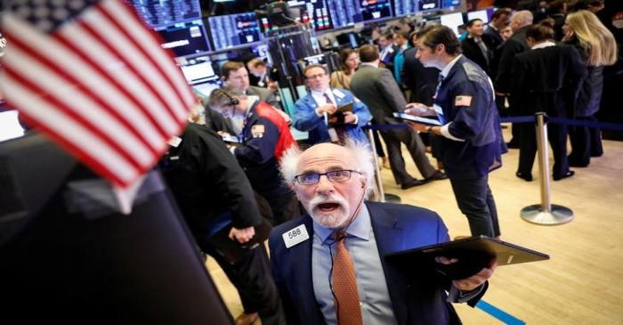 Traders work on the floor at the NYSE in New York