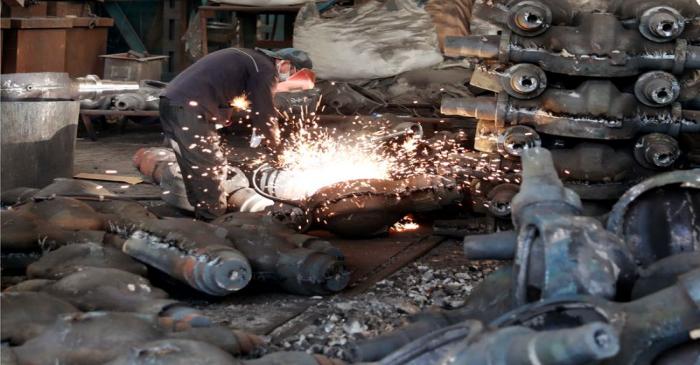 Worker welds automobile parts at a workshop manufacturing automobile accessories in Huaibei,